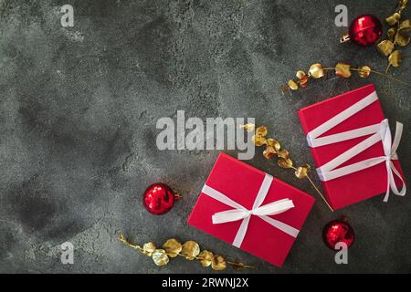 Christmas composition with golden branches, gifts and decoration on dark. Flat lay Stock Photo