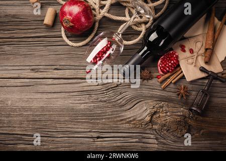 https://l450v.alamy.com/450v/2rwnkw6/ripe-pomegranate-fruit-with-a-glass-of-wine-a-bottle-on-a-wooden-background-top-view-with-copy-space-2rwnkw6.jpg