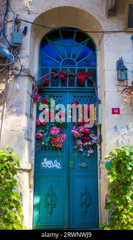 door with flowers in a historic area in the old part of fatih, balat, istanbul Stock Photo