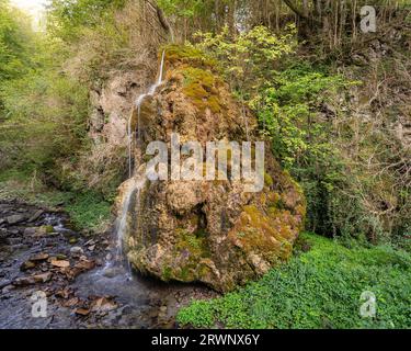 Scenic landscape view of waterfall on rock covered in limestone and moss in the Boulzane river valley, Pyrenees mountains, Gincla, Aude, France Stock Photo