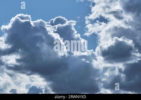 Clouds against blue sky are illuminated by bright summer sun Stock Photo