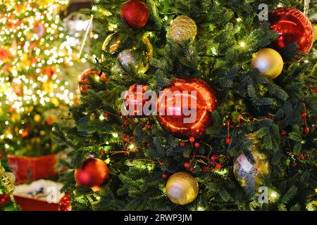 Beautiful decorated Christmas tree on blurred, sparkling and fairy background. New Year mood. Stock Photo