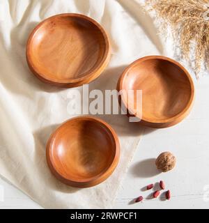handmade wooden craft bowls on white table Stock Photo