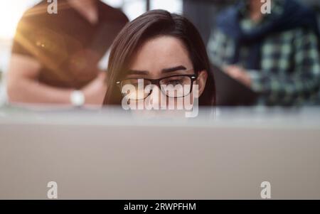 Confident businesswoman wearing casual clothes while sitting at office and working Stock Photo