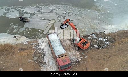 Workers use heavy trucks to transport ice, North China Stock Photo