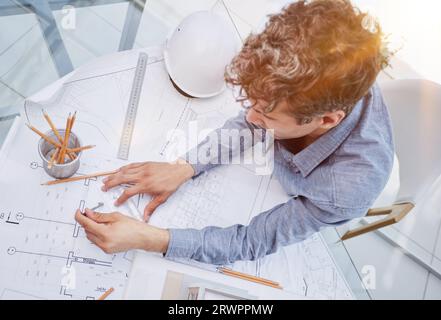 Young handsome architect engineer working on design plan Stock Photo