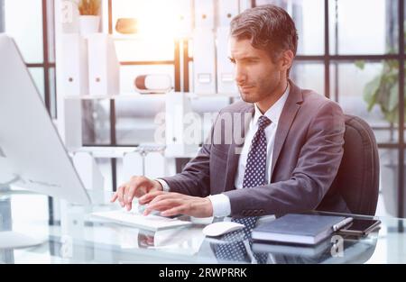 Busy accountant uses notebook PC and has easy access to all e-files in enterprise digital database Stock Photo