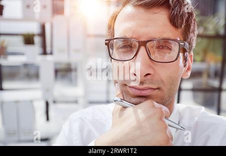 close-up. pensive young businessman in the office looking away. Stock Photo