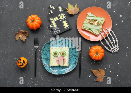 Composition with funny Halloween breakfast and decorations on dark background Stock Photo