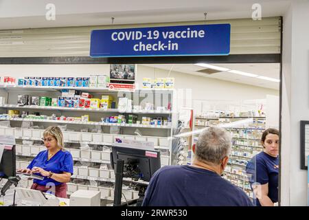 Miami Beach Florida,Walgreens Pharmacy drugstore,inside indoors interior,counter Covid-19 vaccine check-in coronavirus pandemic,man men male,woman wom Stock Photo