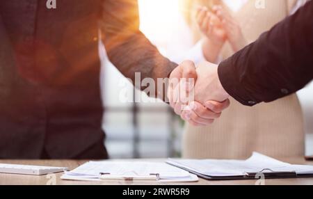 Close up of business people shaking hands at meeting or negotiation in the office. Stock Photo