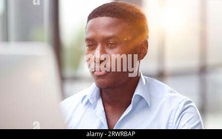 Thoughtful black man in eyeglasses stack with hard task, looking at computer screen, thinking of problem solution Stock Photo