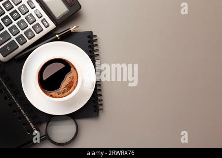 Top view of Gray stylish workplace with smartphone and office supplies on black leather table background . High quality photo Stock Photo