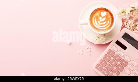 Office pink table, notepad, keyboard, flowers, coffee, hat, notebook, stationery on pink background. Business minimal concept for women. Flat lay, top Stock Photo