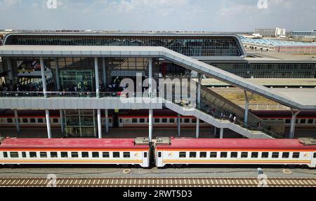 (230921) -- NAIROBI, Sept. 21, 2023 (Xinhua) -- This aerial photo taken on Sept. 20, 2023 shows passengers preparing to board the train to Mombasa at Nairobi Terminus Station of the China built Mombasa-Nairobi Standard Gauge Railway (SGR) in Nairobi, Kenya. In 2017, the SGR, built and operated by China Road and Bridge Corporation, was officially opened to traffic. As the first railway built since Kenya's independence, it runs 480 km between the capital Nairobi and the port city of Mombasa. Cutting the travel time between the two cities by five hours, it also reduces overall logistics costs by Stock Photo