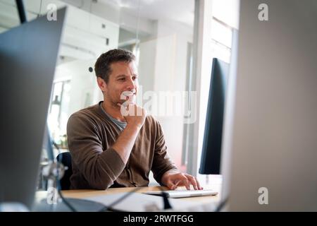 Programmer, web developer, designer working at office comparing mobile and desktop website versions Stock Photo