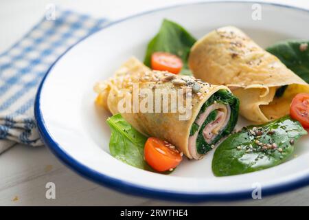 Crepe stuffed with ham and spinach. Stock Photo