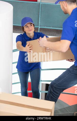 smiling young woman courier deliverywoman Stock Photo