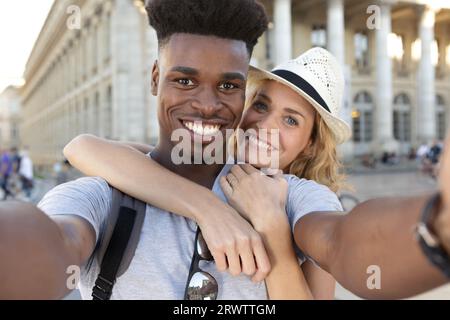 loving mixed couple taking selfie with smartphone together Stock Photo