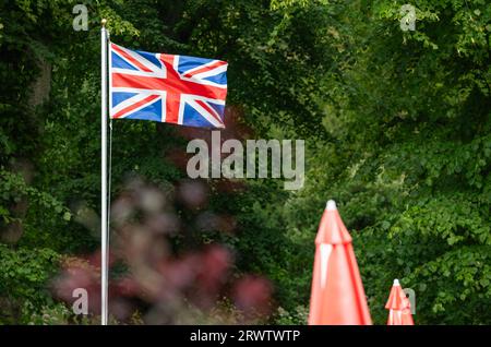 Union Jack Flag or Union Flag flying outside at a cafe in the UK. Stock Photo