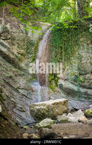 Hidden forest waterfall in the mountain Stock Photo