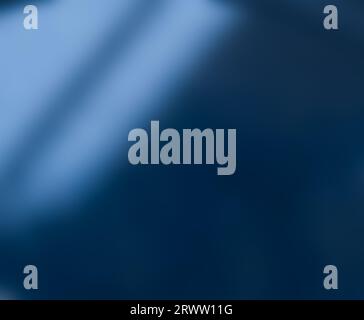 Defocused blurred abstract background, light from a window on a blue wall or in a blue room Stock Photo