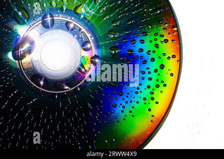Stunning water drops on dark CD surface with white background abstract asset art Stock Photo