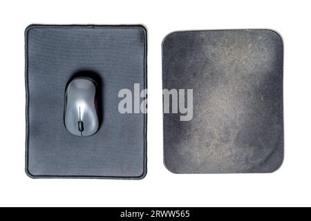 Brand new clean computer mouse pad and a well-used dirty one placed side by side isolated on a white background. Stock Photo