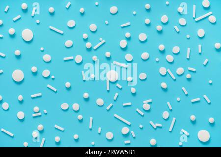 flat lay of white sprinkles over blue background, decoration for banner, poster, flyer, card, postcard, cover, brochure, designers. Stock Photo