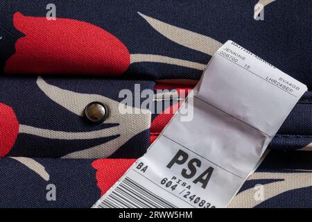 BA British Airways luggage label stuck on case for PSA Pisa airport in Italy Stock Photo