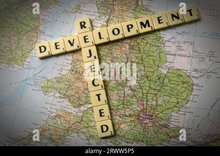 Development Rejected spelled out in Scrabble letters and words on a map of England - local development and building control Stock Photo