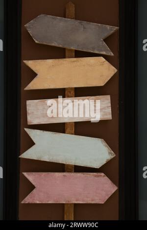 Vintage post with several woods shaped like arrows that indicate in various directions Stock Photo