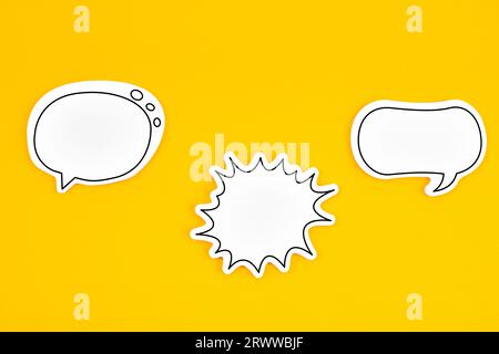 Blank white speech bubble isolated on yellow background. Stock Photo
