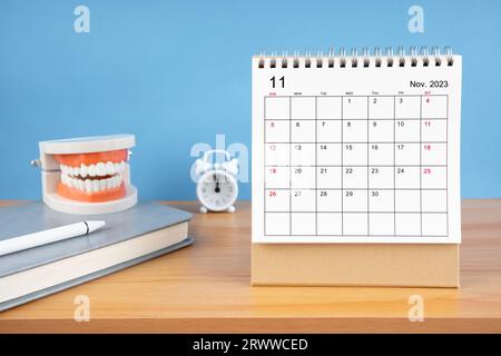 April monthly desk calendar for 2024 year and model dentures on the table.  Dental health concepts Stock Photo - Alamy