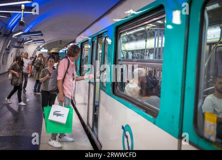 Passengers board a Paris Metro train at  Gambetta Station on Line 4 in Paris, France. Stock Photo
