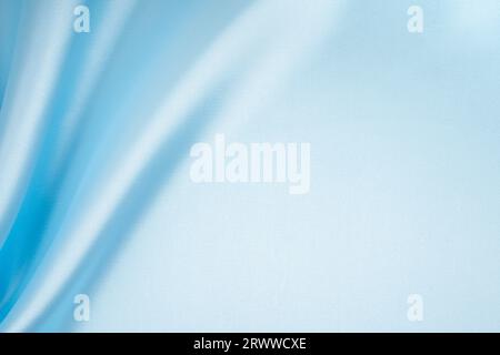 Light blue crumpled silk fabric texture background. Close up. Stock Photo