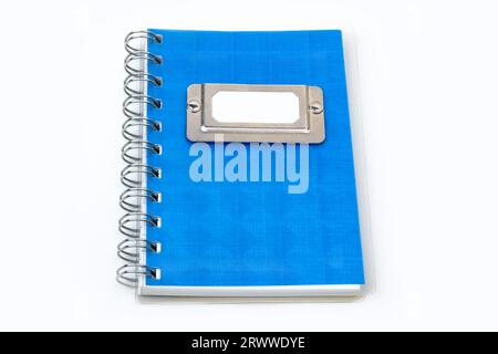 Blue notebook with metallic label isolated on a white background. Stock Photo