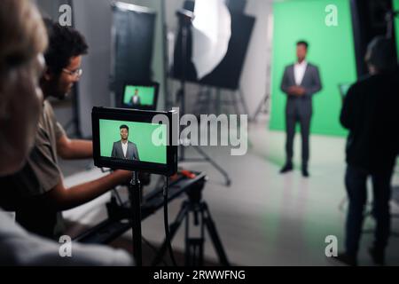 Videomaker shooting journalist for broadcast in professional studio Stock Photo