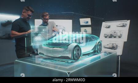 Two professional automotive engineers choose body of new eco-friendly electric car using futuristic augmented reality hologram. 3D computer graphics of vehicle high-tech developing. VFX animation. Stock Photo