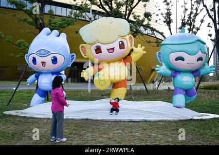 Hangzhou, China's Zhejiang Province. 9th Nov, 2021. A girl poses with Chenchen, Congcong and Lianlian (from L to R), mascots of the 19th Asian Games, at the Gongshu Canal Sports Park in Hangzhou, east China's Zhejiang Province, Nov. 9, 2021. Credit: Huang Zongzhi/Xinhua/Alamy Live News Stock Photo