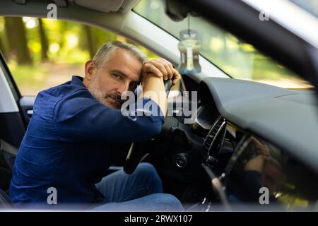 Young man sitting inside car is very upset and stressed Stock Photo