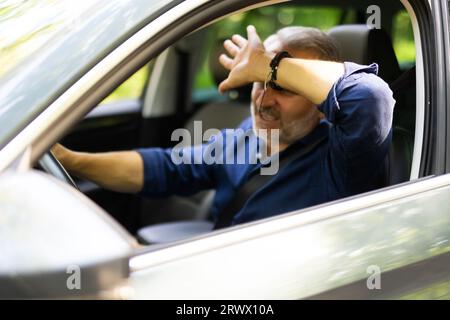 Feeling Anxiety. Exhausted, overloaded man closing eyes with hand, experiencing headache or stress Stock Photo