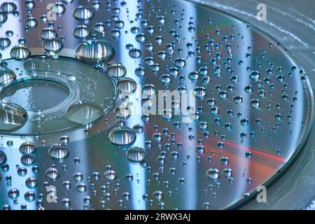 Silvery blue surface and background with water drops on CD in abstract art background asset Stock Photo