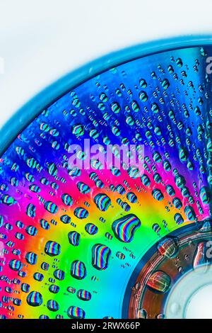 Brilliant burst of rainbow colors on metallic surface with water drops abstract background asset Stock Photo