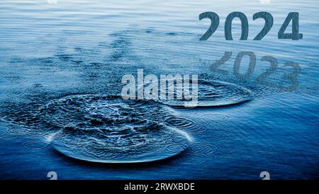 Transition from 2023 to new year concept with 2024 text on sea. Happy New Year 2024 is coming. High resolution photo image can be used as large banner Stock Photo