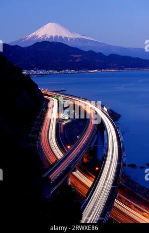 Fuji from Satsuta Pass and light traces of cars on the road Stock Photo