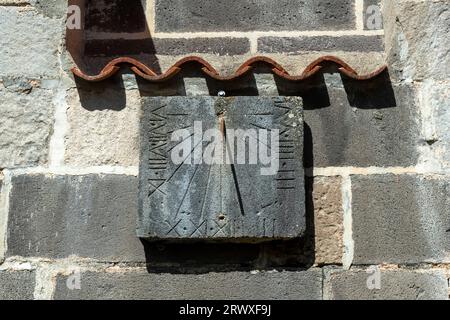 Mozac. Saint-Pierre Abbey Church . Sundial in the cloister. Puy de Dome department. Auvergne-Rhone-Alpes. France Stock Photo