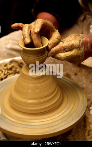 Potter hands shaping up the clay of the pot Stock Photo - Alamy