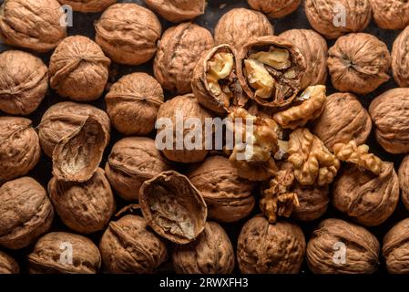 Walnuts with and without shells (filling the picture). Background of fresh walnuts. Stock Photo
