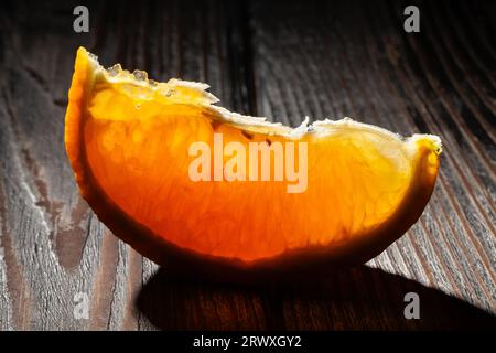 sliced orange on wood background Stock Photo